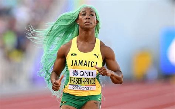 Shelly-Ann Fraser-Pryce adjusts her wig during 200m heats